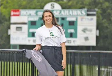  ?? STAFF PHOTO BY TROY STOLT ?? Silverdale Baptist Academy senior Carrie Patrick, who ran track and played soccer for the Lady Seahawks, designed and sold T-shirts to raise funds that will help Grace Baptist Academy rebuild after the K-12 school and church experience­d major damage during an April 12 tornado.