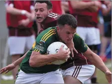  ??  ?? CTI Business Solutions IFC Group C Kevin Keogh tries to halt Conor McGuinness’ break from defence.