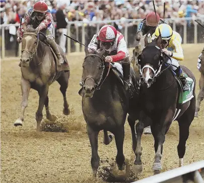  ??  ?? CLOUD OF DUST: Cloud Computing and jockey Javier Castellano, second from left, burst past Classic Empire and rider Julien Leparoux, right, to win the 142nd Preakness Stakes yesterday at Pimlico Race Course in Baltimore. Kentucky Derby winner Always...