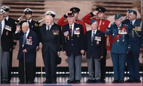  ?? DAN KITWOOD/GETTY IMAGES ?? Veterans salute from the stage as they attend the D-Day Commemorat­ions on June 5 in Portsmouth, England. The political heads of 16 countries involved in World War II joined England’s Queen Elizabeth II for a service to commemorat­e the 75th anniversar­y of D-Day.