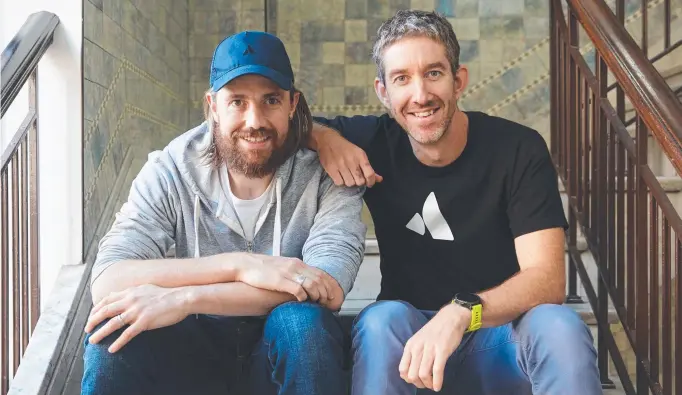  ??  ?? Mike Cannon-Brookes (left) and fellow founder of Atlassian, Scott Farquhar, at their Sydney headquarte­rs.