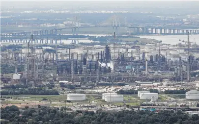  ?? Michael Ciaglo / Houston Chronicle ?? An Exxon Mobil Baytown facility is seen from a helicopter this week. Some refineries have begun the restart process.