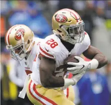  ?? John Froschauer / Associated Press ?? The 49ers’ Carlos Hyde, taking a handoff from Brian Hoyer, rushed for 124 yards, the third-highest total of his career.