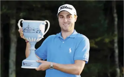  ??  ?? NORTON: Justin Thomas holds the trophy after winning the Dell Technologi­es Championsh­ip golf tournament at TPC Boston in Norton, Mass. Monday. —AP