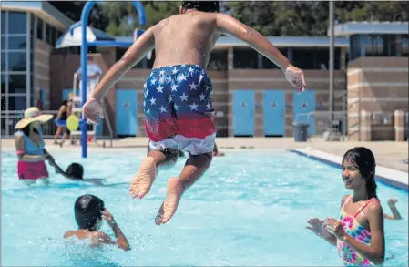  ?? PHOTO BY SHAE HAMMOND ?? Tristen Gill leaps into the community pool at Northridge Recreation Center on Saturday as he and his friends get a jump on the long holiday weekend.