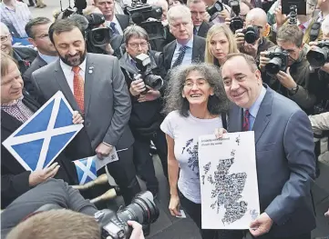  ??  ?? Salmond (right) is surrounded by media and supporters as he attends an event with pro-independen­ce supporters and European citizens to celebrate European citizenshi­p and Scotland’s continued EU membership with a Yes vote, during a photocall in...