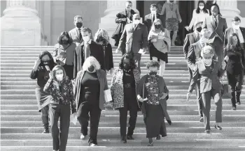  ?? J. SCOTT APPLEWHITE/AP ?? House Speaker Nancy Pelosi, D-Calif., second left, and members of the Democratic Caucus walk down stairs Wednesday outside the U.S. Capitol to address reporters.