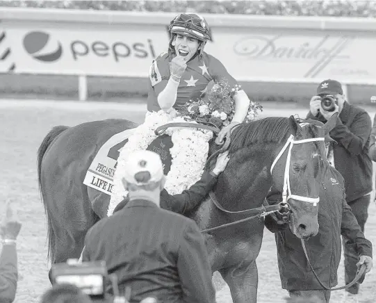  ?? MICHAEL LAUGHLIN/SUN SENTINEL ?? Jockey Irad Ortiz Jr., on Life is Good, celebrates winning the Pegasus World Cup race Jan. 29 at Gulfstream Park in Hallandale Beach.