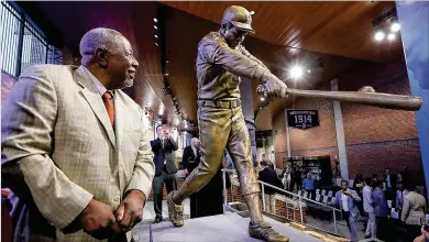  ?? CURTIS COMPTON/AJC 2017 ?? In 2017, Hall of Fame slugger Hank Aaron, then a Braves senior vice president, attends an unveiling of a statue honoring him in Monument Garden at Suntrust Park, recently renamed Truist Park.