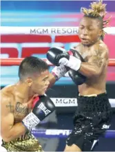  ?? GETTY IMAGES ?? Chicago native Joshua Greer Jr. (right) was upset by Mike Plania in a 10-round bantamweig­ht fight Tuesday night in Las Vegas.