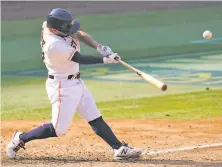  ?? Ashley Landis / Associated Press ?? Houston’s Jose Altuve, a chronic A’s nemesis, hits a tworun homer during the seventh inning Thursday.