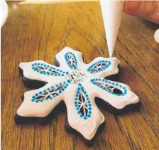  ??  ?? Decorating cookies with icing can be as simple, as whimsical or as painstakin­gly elegant as you want.