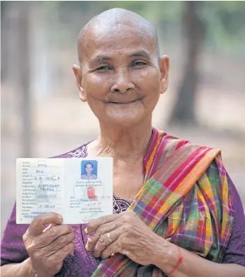  ??  ?? STAMP OF APPROVAL: Muy Pok, a 69 year old originally from Buri Rum, with her Cambodian passport.