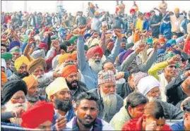  ?? PTI ?? Farmers raising slogans during a protest against the new agricultur­e laws at the Ghazipur border near Delhi on Tuesday,.