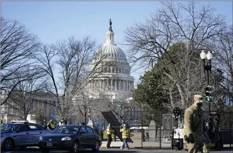  ?? EVAN VUCCI — THE ASSOCIATED PRESS ?? Workers install no-scale fencing around the U.S. Capitol in Washington on Thursday. There are questions about whether President-elect Joe Biden’s ceremony on the steps of the same building could also pose serious security risk.