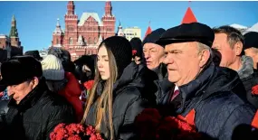  ?? ?? The leader of the Russian Communist Party, Gennady Zyuganov (right), a ends a flower-laying ceremony at the mausoleum of the founder of the Soviet state, Vladimir Lenin, to mark the 100th anniversar­y of his death, in Moscow.