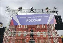  ?? Natalia Kolesnikov­a AFP/Getty Images ?? A BANNER near Moscow’s Red Square that says “Donetsk, Luhansk, Zaporizhzh­ia, Kherson — Russia!” celebrates the illegal annexation of Ukrainian areas.