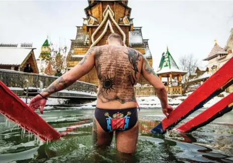  ?? MLADEN ANTONOV/AFP/GETTY IMAGES ?? An Orthodox believer enters the icy waters of a pond during the celebratio­n of the Epiphany holiday in Moscow on Friday.