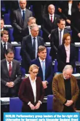  ?? —AFP ?? BERLIN: Parliament­ary group leaders of the far-right AfD (Alternativ­e for Germany) party Alexander Gauland (front right) and Alice Weidel (front left) and other AfD members of parliament stand to pay their respects to a recently deceased MP yesterday.