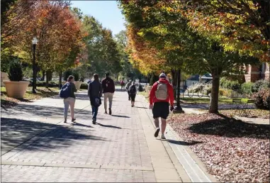  ?? ?? MSU students are pictured walking on the university’s Old Main Plaza, framed by autumn leaves. The university is reporting its seventh year of consecutiv­e growth for 2021, with a total fall headcount of 23,086 students enrolled. (Photo by Megan Bean, MSU)