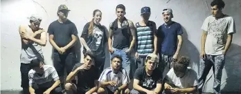  ?? U.S. ATTORNEY FOR THE EASTERN DISTRICT OF VIRGINIA ?? Shannon Sanchez, standing third from left, poses with a group that includes MS-13 gangsters. Some American MS-13 chapters allow women to become members.