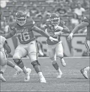  ?? CRAVEN WHITLOW/NATE Allen Sports Service ?? Razorback senior offensive lineman Myron Cunningham, 76, clears a running hole against Portland State University last season at Donald W. Reynolds Razorback Stadium in Fayettevil­le.