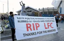  ?? GETTY IMAGES ?? Fans hold up a banner in protest against the European Super League outside the stadium prior to the Premier League match between Leeds United and Liverpool at Elland Road yesterday.