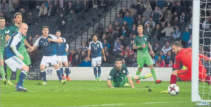  ?? Picture: SNS ?? BETTER LATE THAN NEVER: Substitute Chris Martin’s left-foot shot with just two minutes remaining thwarts Jan Oblak in the Slovenia goal to give Scotland a precious three points in Group F.