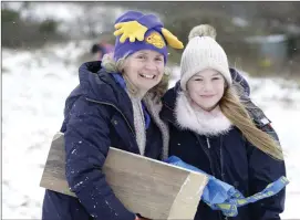  ??  ?? Claire and Elsa Micallef sledding on Bray Head.