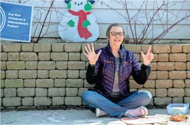  ?? ZHIHAN HUANG/MILWAUKEE JOURNAL SENTINEL ?? Meredith Grob Polewski records a video for her students in front of her house on Wednesday. Polewski is a K-4 teacher. She started recording lessons for her students this month when they were told they couldn’t go back to the classroom.