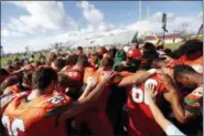  ?? GERALD HERBERT — THE ASSOCIATED PRESS ?? Coaches and players from Mosley High pray together Saturday after their loss to Pensacola High, in the aftermath of Hurricane Michael in Panama City, Fla.