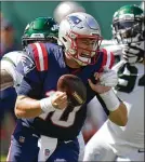  ?? PHOTOS BY FRANK FRANKLIN II/AP ?? Patriots quarterbac­k Mac Jones, the 15th overall pick, is sacked by Jets defensive end John Franklin-myers during the first half Sunday.