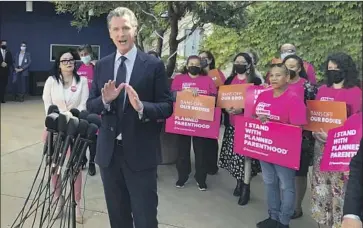 ?? GOV. GAVIN Michael R. Blood Associated Press ?? Newsom at a news conference Wednesday with workers and volunteers at a Planned Parenthood office near downtown Los Angeles. “We’re not going to roll over, we will not back down,” he said.