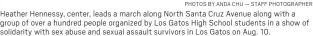  ?? PHOTOS BY ANDA CHU — STAFF PHOTOGRAPH­ER ?? Heather Hennessy, center, leads a march along North Santa Cruz Avenue along with a group of over a hundred people organized by Los Gatos High School students in a show of solidarity with sex abuse and sexual assault survivors in Los Gatos on Aug. 10.