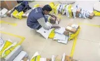 ?? — Bloomberg ?? A worker sorts packages at a Flipkart Online Services office in Bengaluru, India.