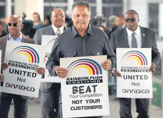  ?? Picture: Getty Images. ?? The Rev Jesse Jackson leads protests against United Airlines after footage emerged of a passenger being dragged off one of its planes for not giving up his seat. Helen says it is symptomati­c of executives thinking they can just do what they like.