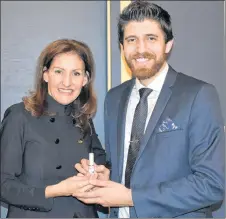  ?? SAM MACDONALD/THE NEWS ?? Barbara Stegemann presents Tareq Hadhad a gift of a chocolate-scented perfume at Game Changers, at the deCoste Performing Arts Centre on Thursday night.