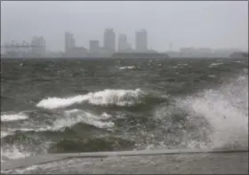  ?? MIKE STOCKER — SOUTH FLORIDA SUN- SENTINEL VIA AP ?? The winds and sea are whipped up off of the Rickenback­er Causeway in Miami as Hurricane Irma approaches on Saturday.