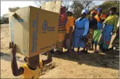  ?? TSVANGIRAY­I MUKWAZHI — THE ASSOCIATED PRESS FILE ?? On Sept. 9, 2015, a child carries a parcel from the United Nations World Food Program in Mwenezi, Zimbabwe. The WFP has won the 2020 Nobel Peace Prize for its efforts to combat hunger and food insecurity around the globe.