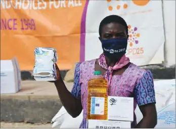  ??  ?? Delight Mukwindits­a shows items she received at the WFP food distributi­on point thanks to funding from the European Civil Protection and Humanitari­an Aid Operations (EU ECHO), among others.