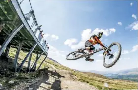  ??  ?? Above Straight out of the gate you’re into a warm-up jump and a fast section of open track and boardwalk Main Many a rider has fallen foul of Fort William’s notorious rocks RightEven the best can slip up in the track’s loose gravel corners – as Peaty demonstrat­es!