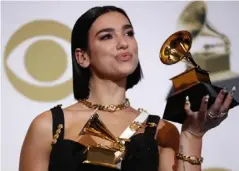  ??  ?? Dua Lipa poses backstage with her Grammys (Reuters)