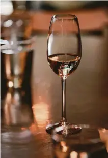  ??  ?? A glass of wine at Terzo. Two bills that aim to legitimize alcohol-related rules are on the governor’s desk.