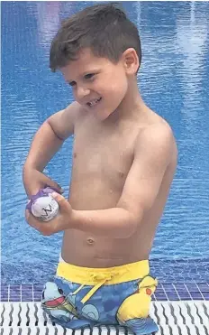  ??  ?? Romeo Hadley at the poolside on holiday in Spain and, right, jumping into the pool and swimming to his dad