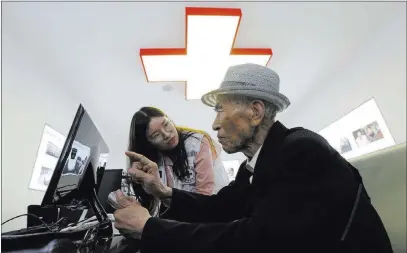  ?? Ahn Young-joon ?? The Associated Press South Korean Yoo Gi-jin, 93, talks with a Red Cross official Friday to fill out applicatio­n forms to reunite with his family members living in North Korea at the headquarte­rs of the Korea Red Cross in Seoul, South Korea.
