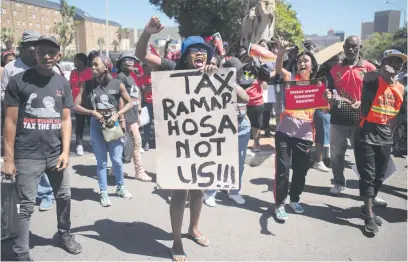  ?? Picture: AFP ?? LEAVE POOR OUT OF IT. Hundreds of people protest against proposed budget and social funding cuts and the South Africa’s overall economic performanc­e before Finance Minister Enoch Godongwana delivered his 2024 Budget speech in parliament yesterday.