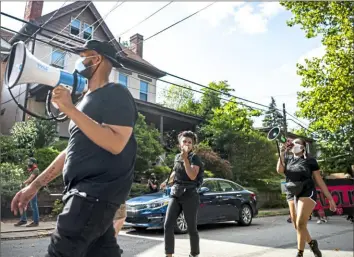  ?? Alexandra Wimley/Post-Gazette ?? Activists lead a march from Mellon Park to Mayor Bill Peduto's house in Point Breeze on Sunday. They were protesting the arrest of an activist who was taken into an unmarked van by plaincloth­es police officers the previous day.