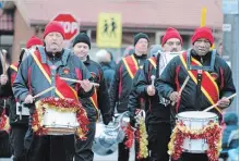  ?? PAUL FORSYTH NIAGARA THIS WEEK FILE PHOTO ?? The Niagara Memorial Militaires Alumni Drum Corps performs in the Thorold Santa Claus Parade. The band, which is switching from marching to riding on a float in parades, has launched a recruitmen­t drive for new members.