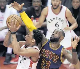  ?? Nathan Denette Associated Press ?? THE RAPTORS’ DeMar DeRozan is fouled by the Cavaliers’ LeBron James during the first half. DeRozan finished with 22 points in a Game 4 loss.