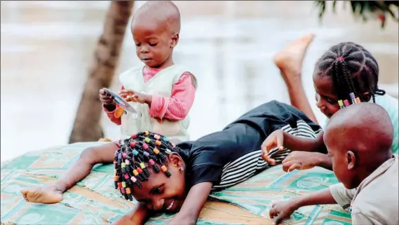  ?? PHOTO LUCY LADIDI ATEKO ?? Kids that survived last year’s flood, with no where to go, still play on mattresses beside the dreadful river in Gwagwalada, Abuja... yesterday.